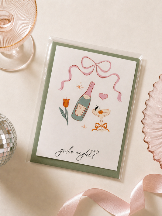 Greeting card with champagne bottle and cocktail illustration on a decorative surface.