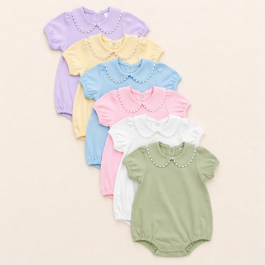 Customizable scalloped collar baby bubble in various colors on soft ivory background