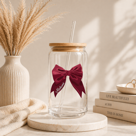 glass iced coffee cup with red bow and Alabama script on neutral aesthetic background with bamboo lid and glass straw