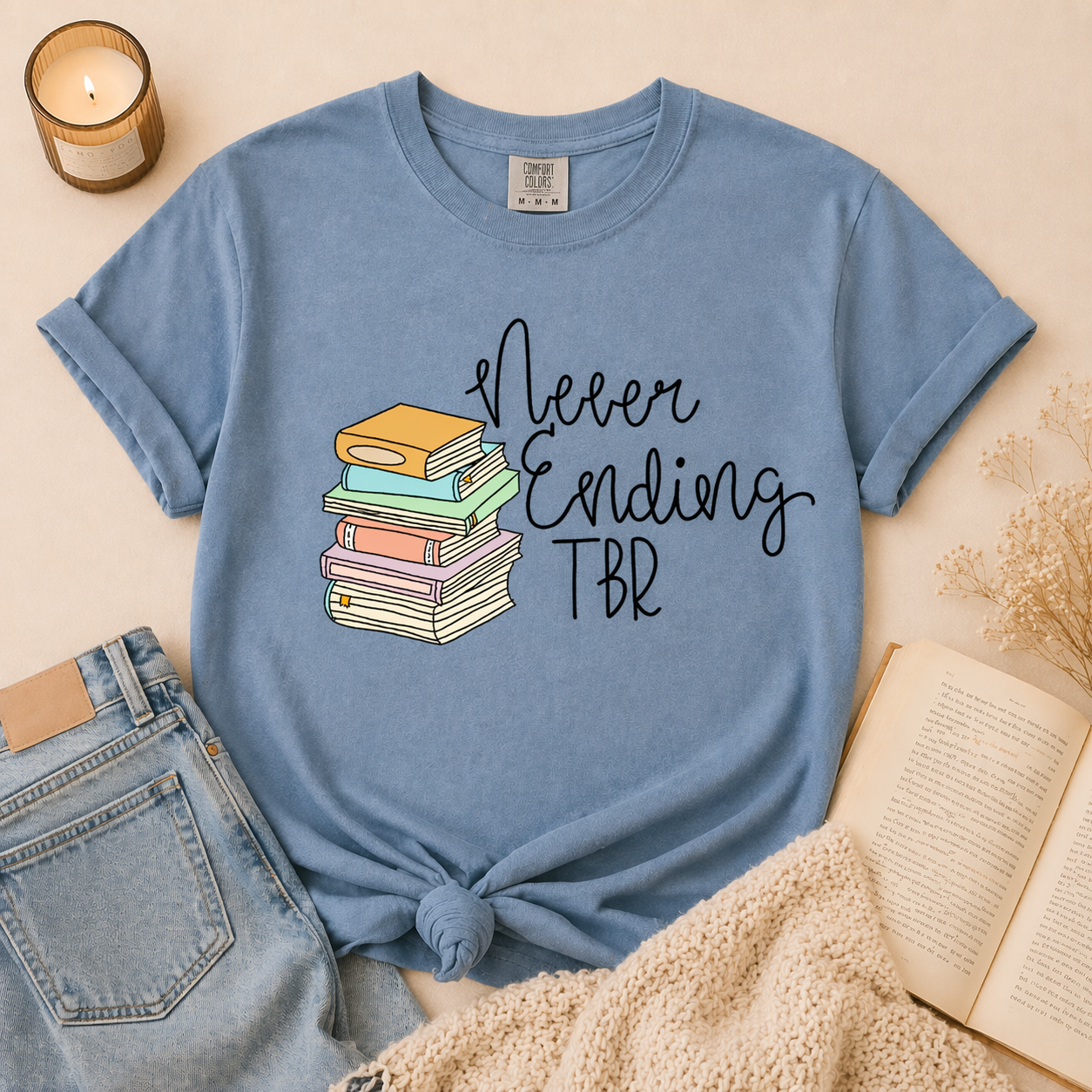 Blue book lover t-shirt with never ending TBR design and stacked books graphic worn in lifestyle photo