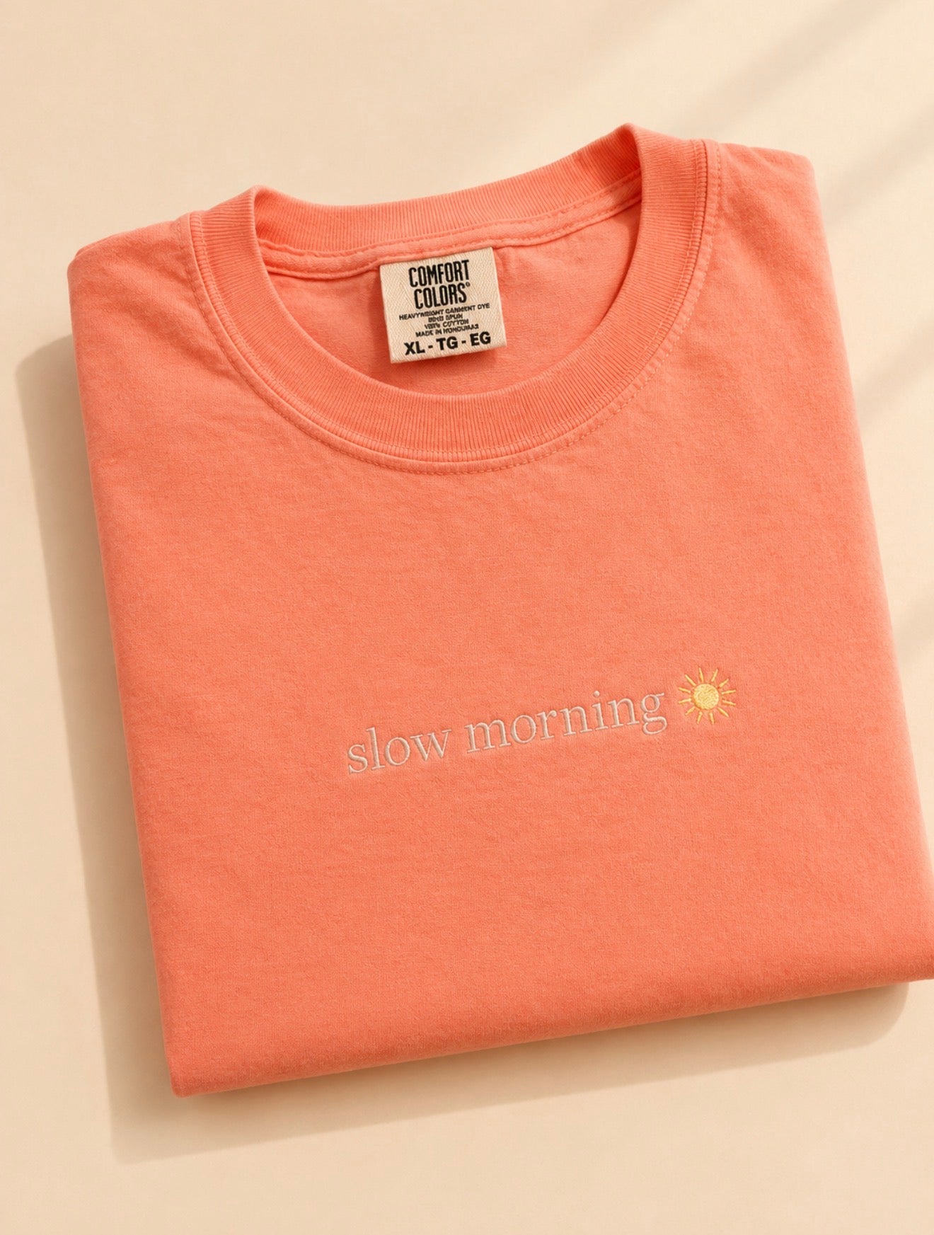 Cream Comfort Colors t-shirt featuring an embroidered “Slow Morning” design across the chest.